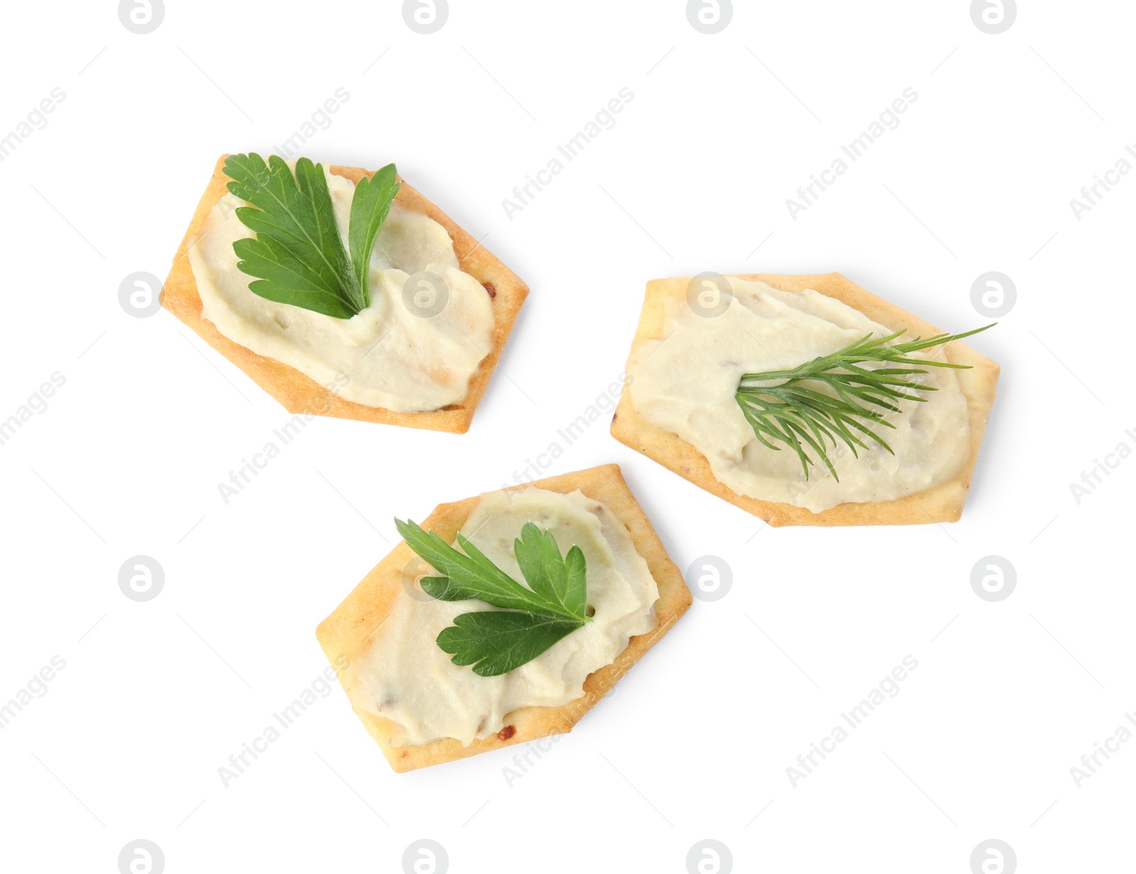 Photo of Delicious crackers with humus, parsley and dill on white background, top view