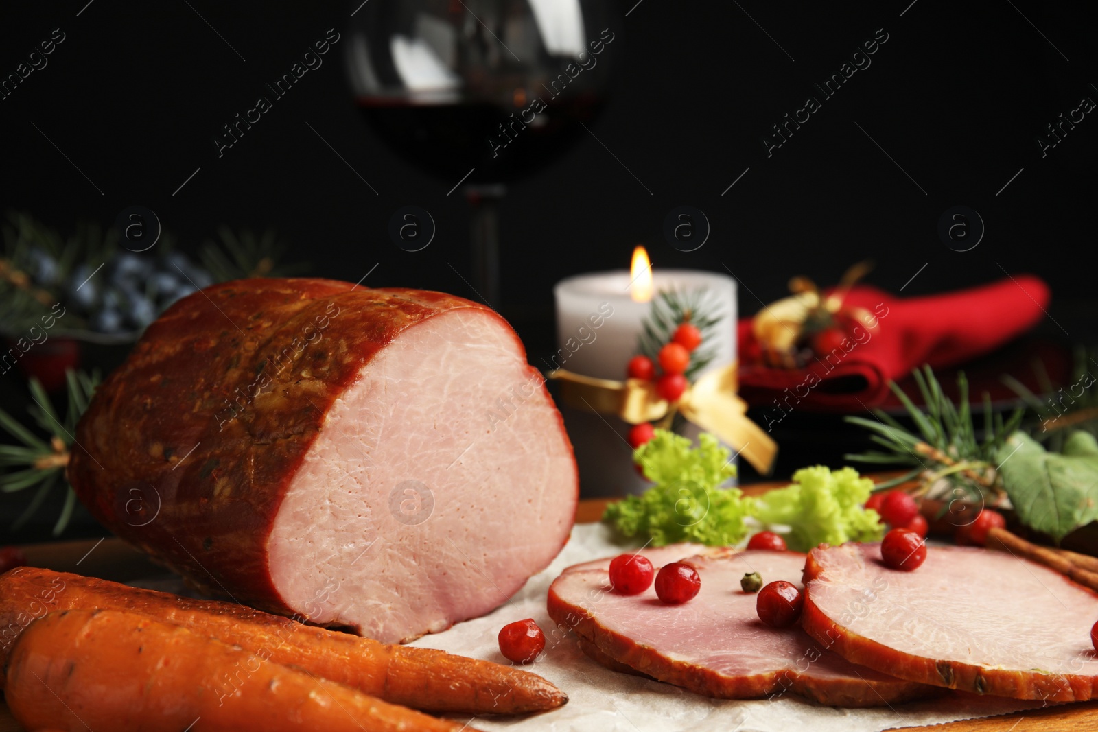 Photo of Delicious ham served on wooden board. Christmas dinner