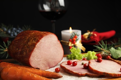 Photo of Delicious ham served on wooden board. Christmas dinner