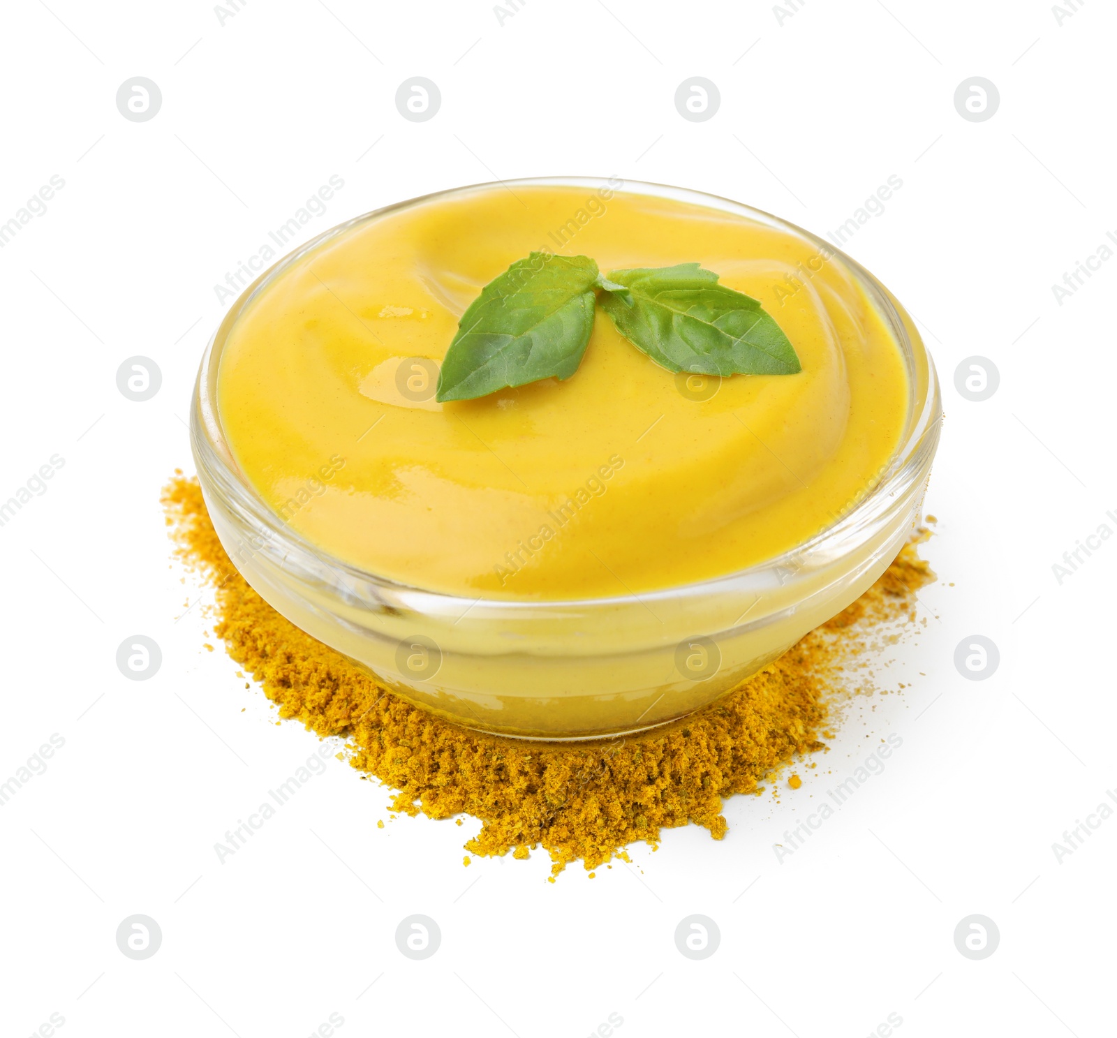 Photo of Bowl with tasty curry sauce, powder and basil isolated on white