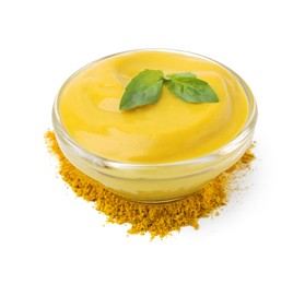 Bowl with tasty curry sauce, powder and basil isolated on white