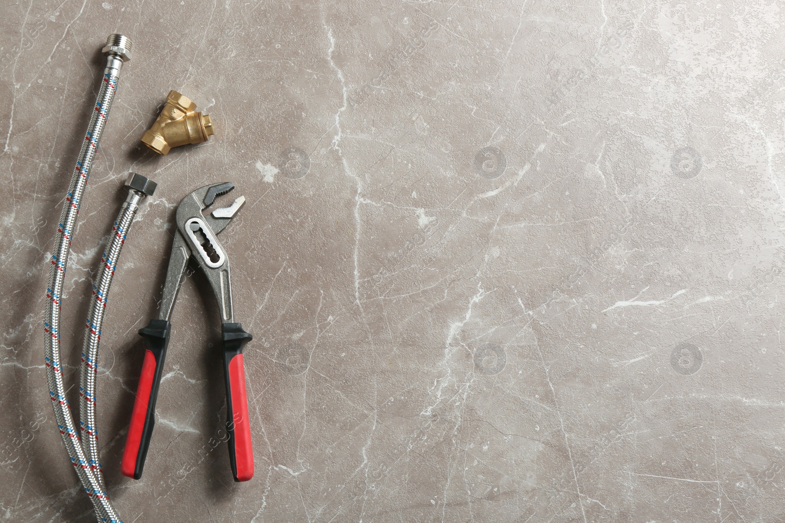 Photo of Flat lay composition with plumber's tools and space for text on grey background