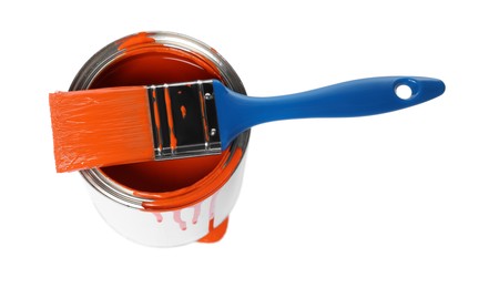 Photo of Can of orange paint and brush on white background, above view