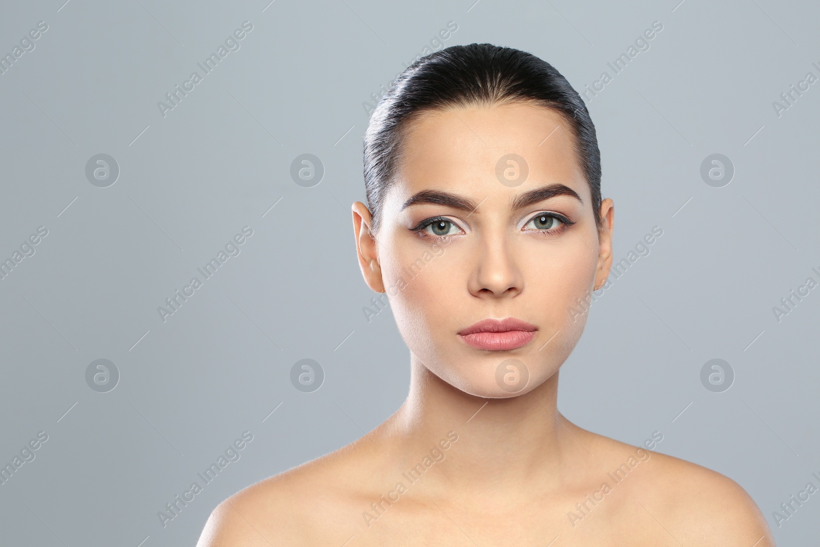 Photo of Young woman wearing beautiful lipstick on color background