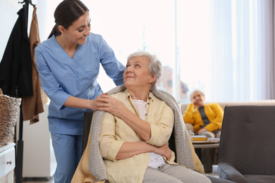 Photo of Nurse taking care of elderly woman in geriatric hospice