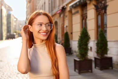 Photo of Portrait of beautiful woman in glasses outdoors, space for text