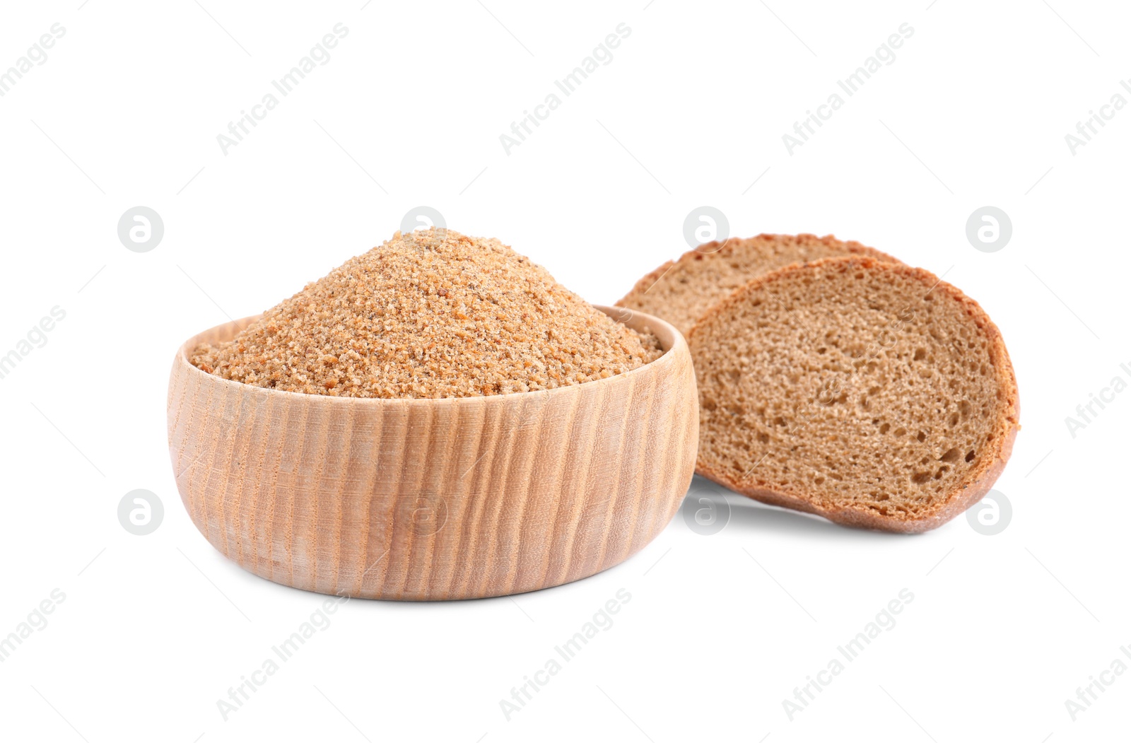 Photo of Fresh bread crumbs in bowl and slices of loaf on white background