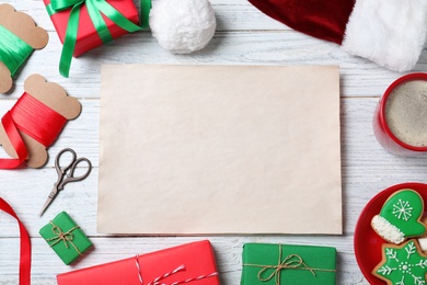 Photo of Flat lay composition with empty card and Christmas decorations on white wooden table, space for text. Writing letter to Santa Claus