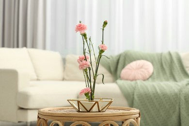 Photo of Ikebana art. Beautiful pink carnation flowers carrying cozy atmosphere at home