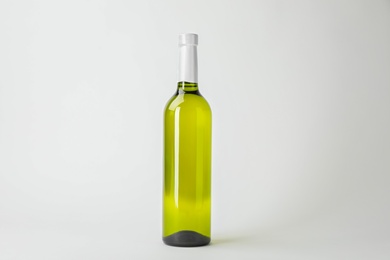 Bottle of expensive wine on white background