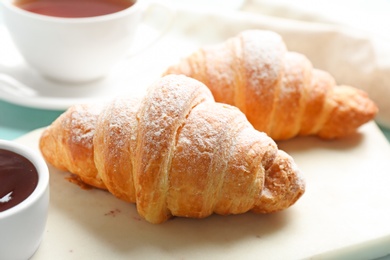 Photo of Marble board with tasty croissants and jam, closeup. French pastry