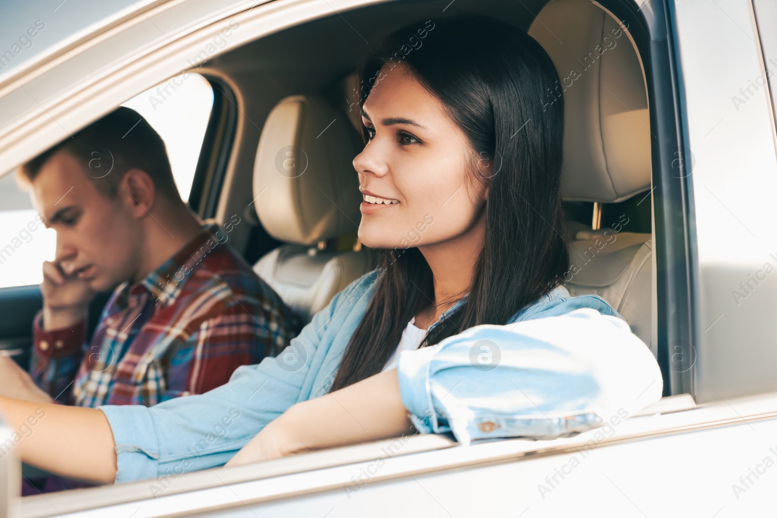 Photo of Happy young couple travelling together by car