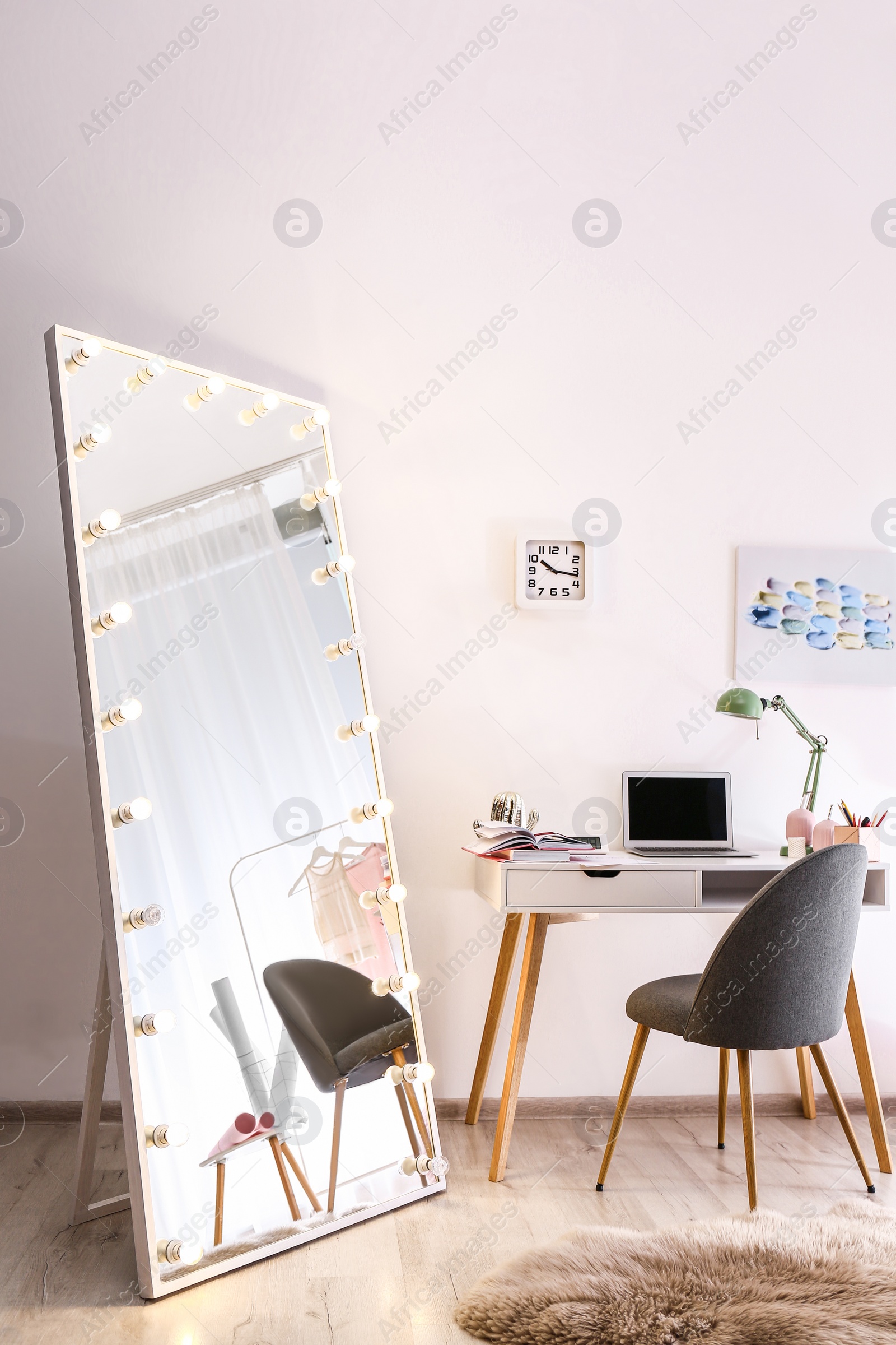 Photo of Large mirror with light bulbs in stylish room interior