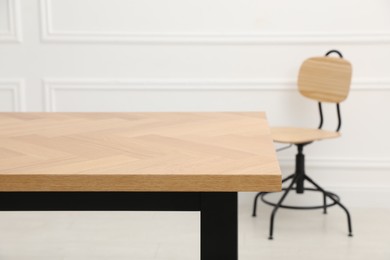 Photo of Wooden table with office chair in room