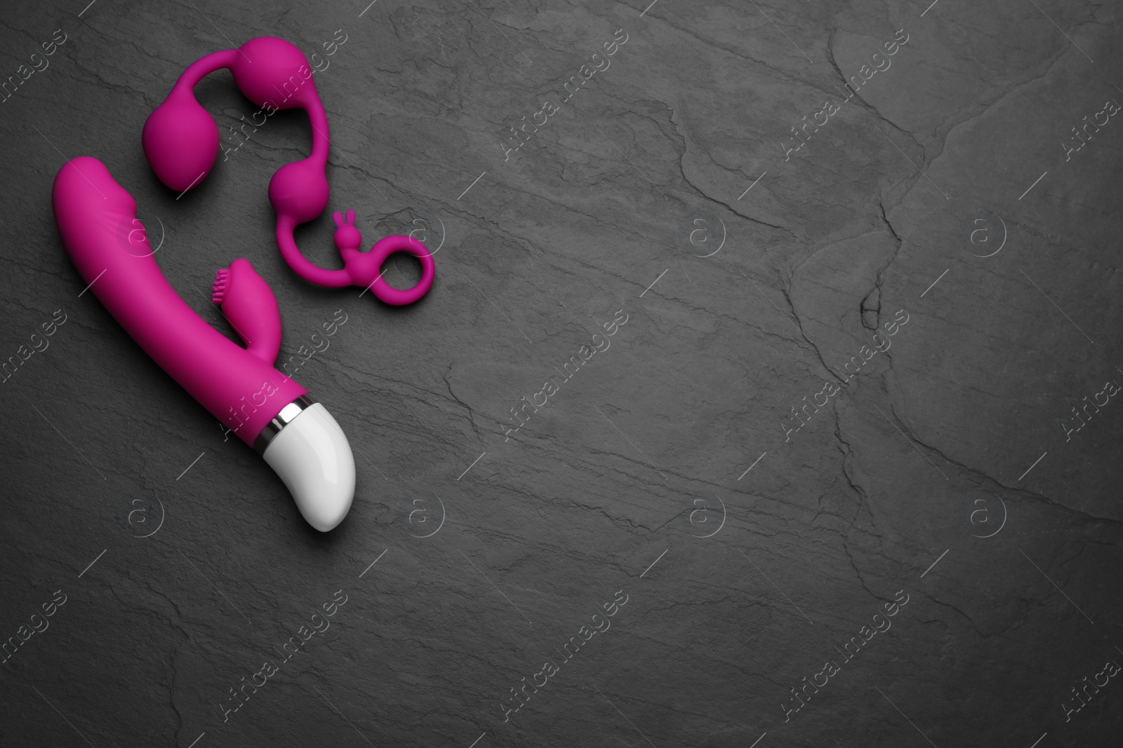 Photo of Sex toys on black background, flat lay. Space for text