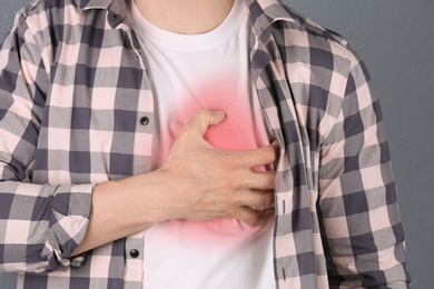 Photo of Young man having heart attack, closeup