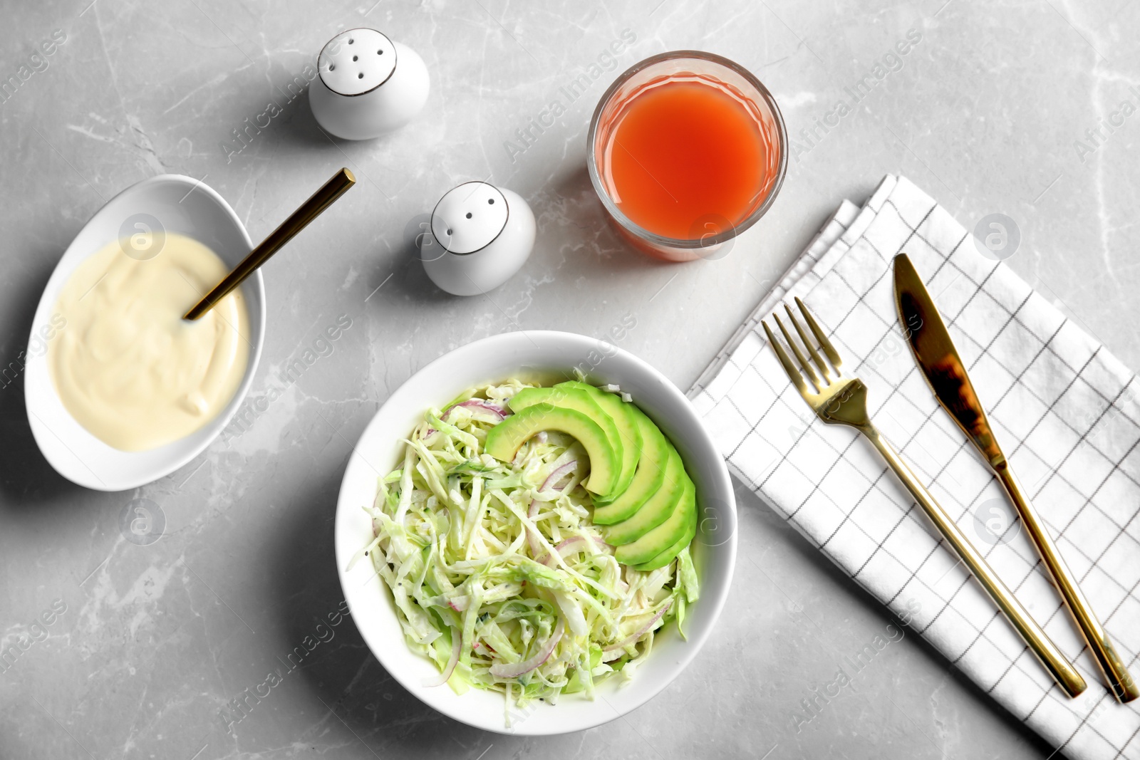 Photo of Flat lay composition with healthy cabbage salad on marble table