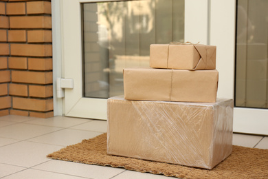 Photo of Delivered parcels on door mat near entrance