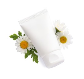 Photo of Tubes of hand cream and chamomiles on white background, top view