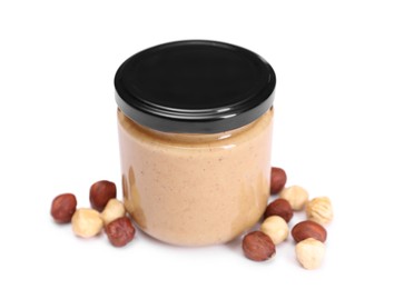 Photo of Tasty nut paste in jar and hazelnuts isolated on white