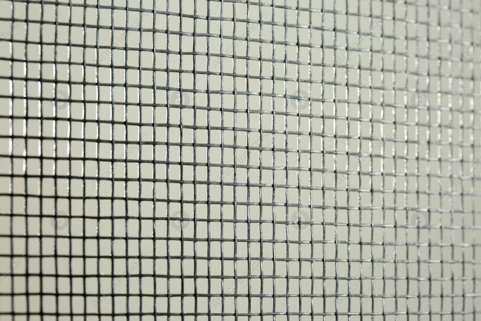 Photo of Closeup view of mosquito window screen on white background