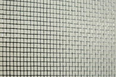 Photo of Closeup view of mosquito window screen on white background