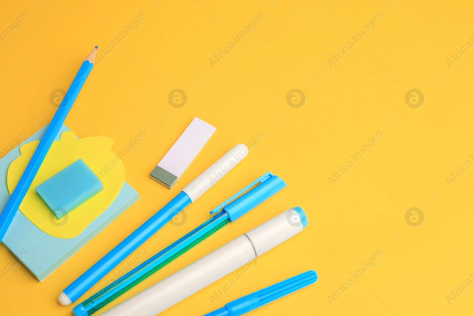 Photo of Different school stationery on yellow background, space for text. Back to school