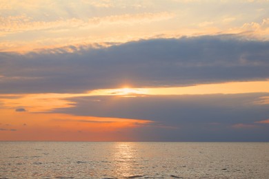 Picturesque view of sunset with beautiful clouds over sea