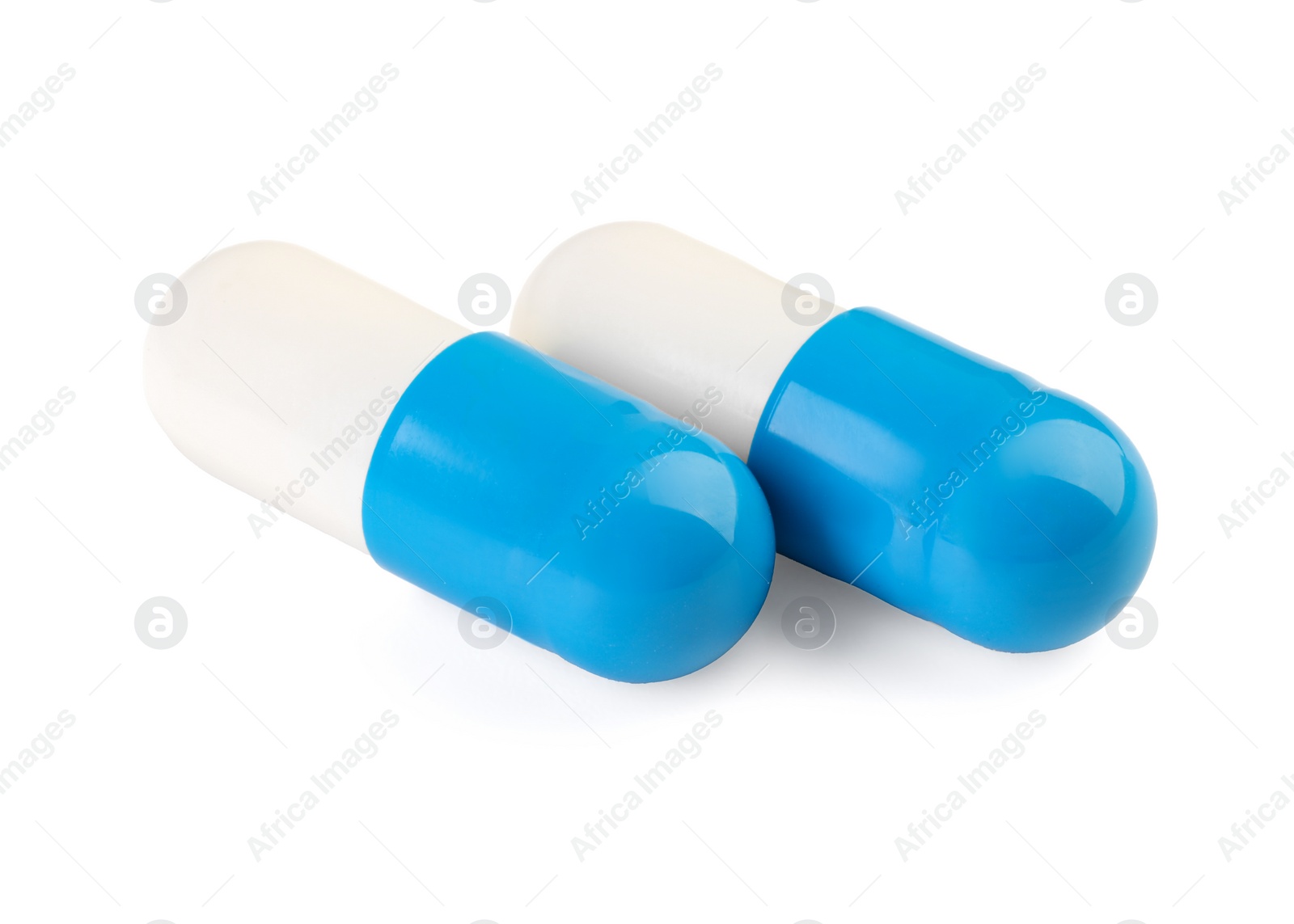 Photo of Two antibiotic pills isolated on white. Medicinal treatment