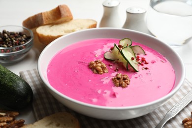 Photo of Delicious cold summer beet soup on table, closeup