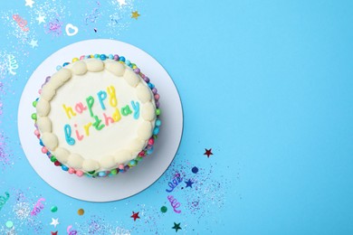 Photo of Cute bento cake with tasty cream and confetti on light blue background, flat lay. Space for text