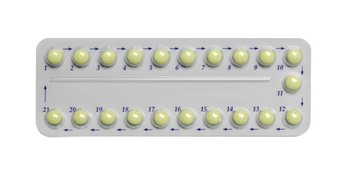 Birth control pills on white background, top view
