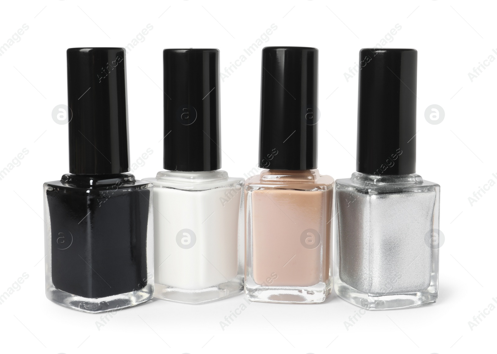 Photo of Beautiful nail polishes in bottles isolated on white