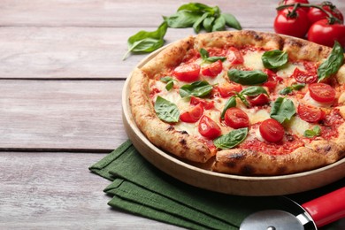 Photo of Delicious Margherita pizza on wooden table, closeup. Space for text