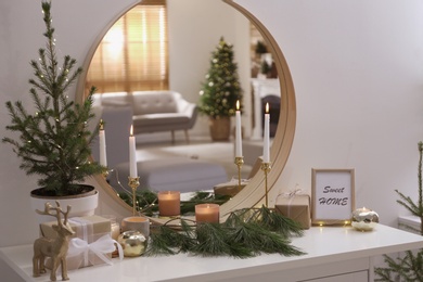Photo of Mirror reflecting beautiful room with Christmas tree. Interior design