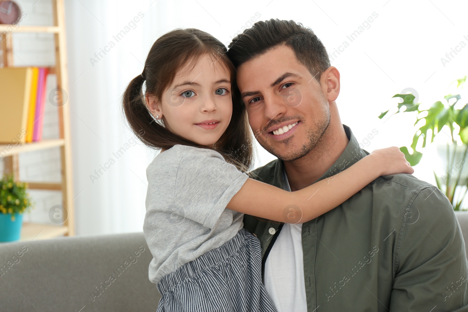 Photo of Dad and daughter spending time together at home. Happy Father's Day