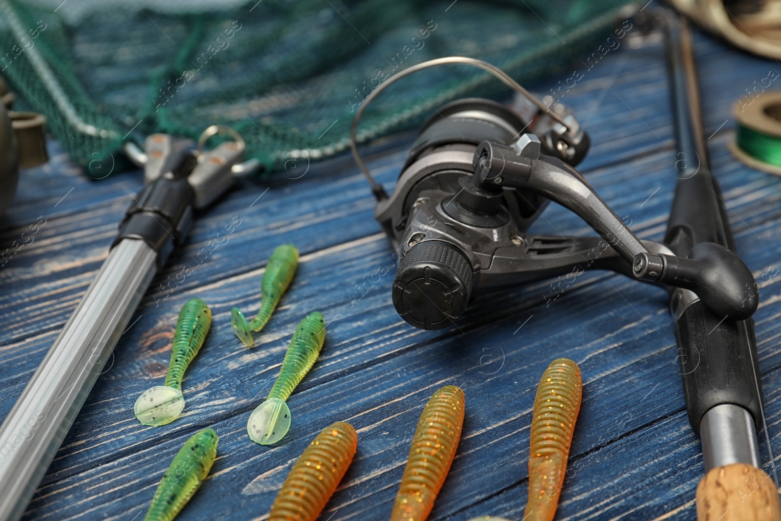 Photo of Fishing tackle on wooden table. Recreational activity