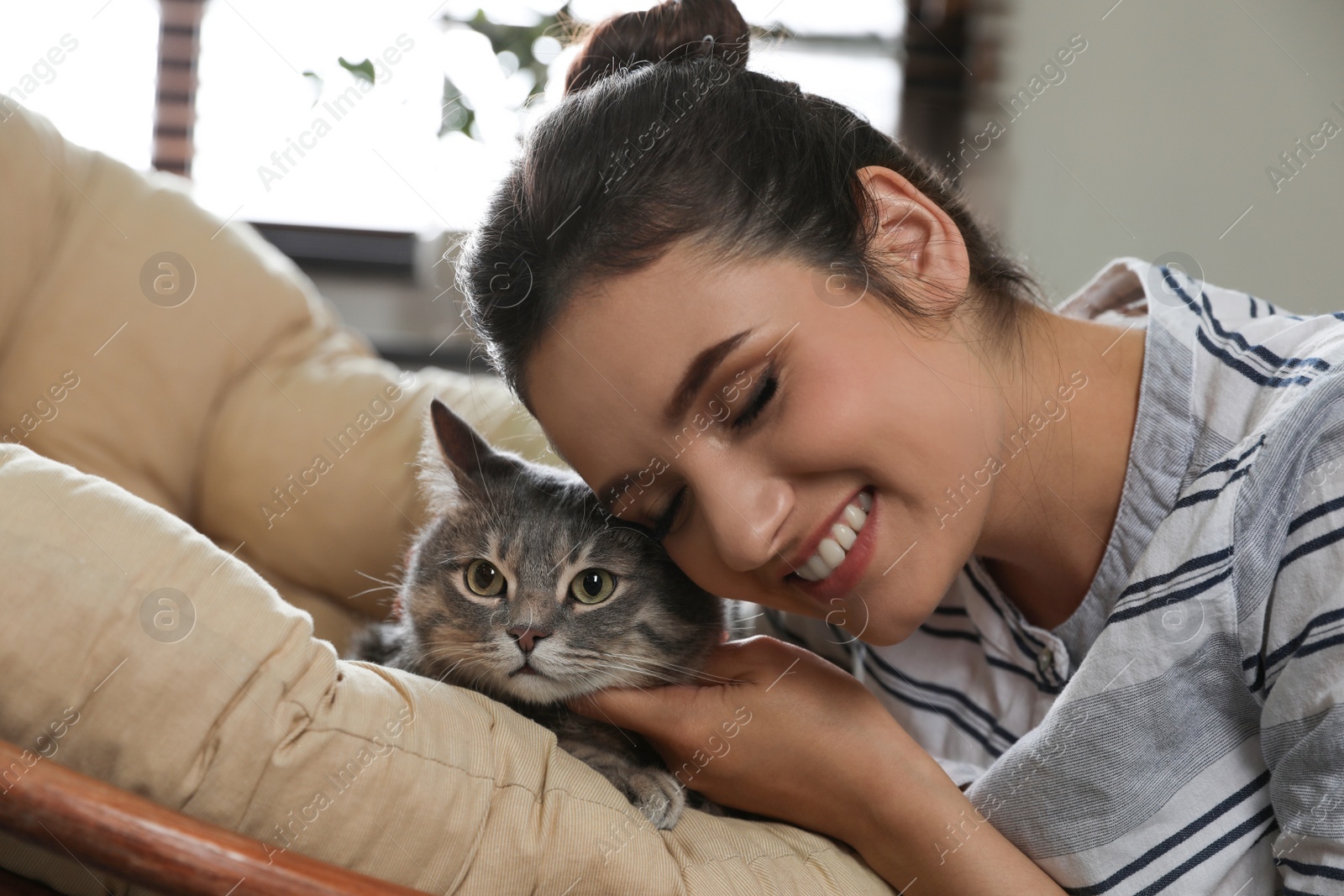 Photo of Young woman with cute cat at home. Pet and owner