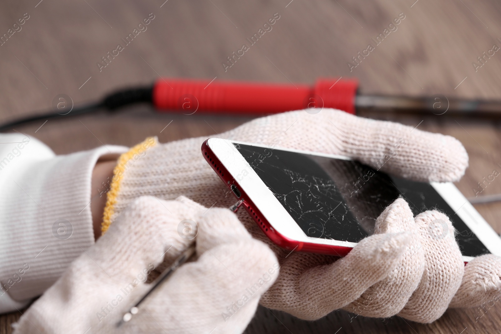 Photo of Technician fixing mobile phone at table, closeup. Device repair service