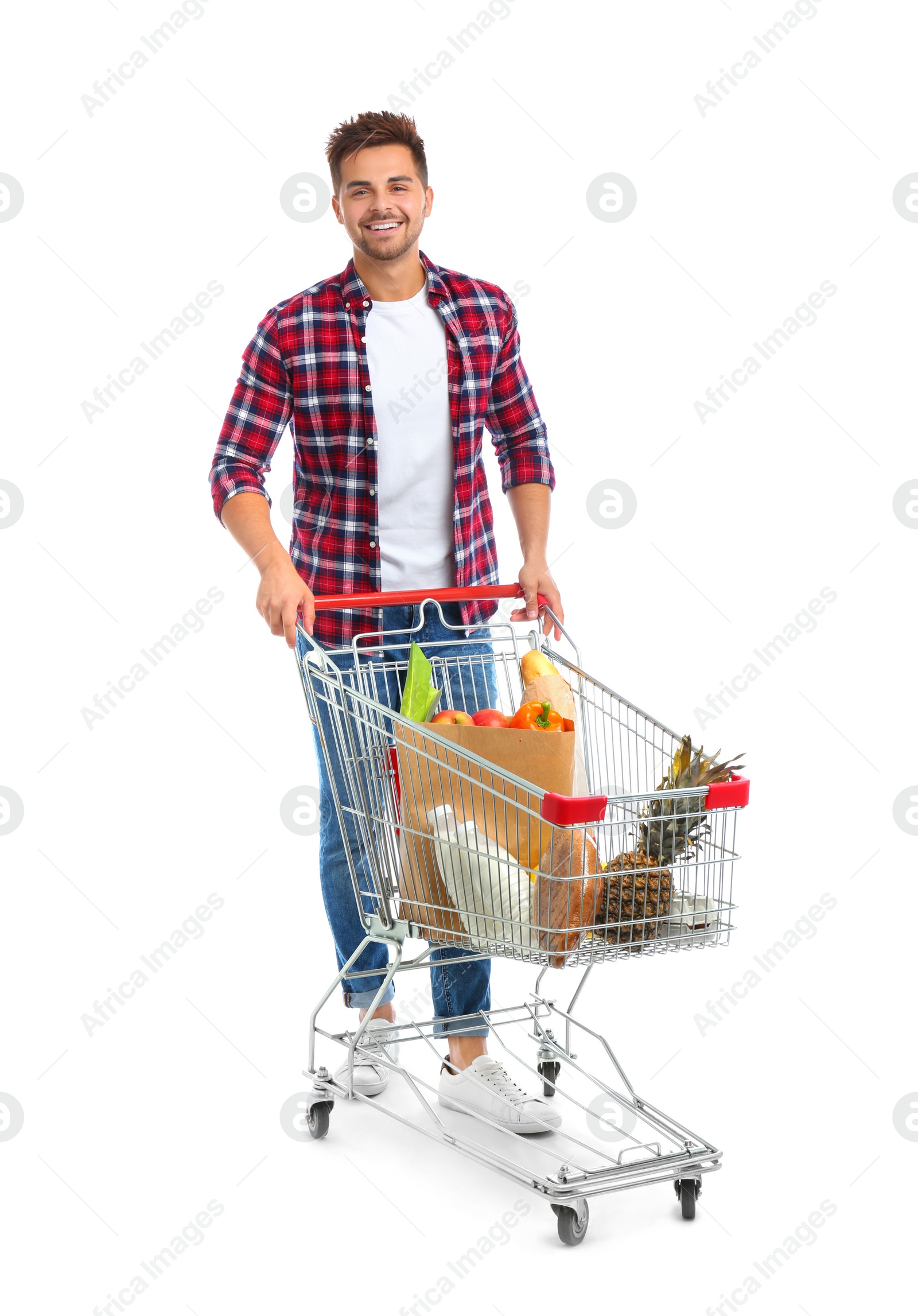 Photo of Young man with full shopping cart on white background