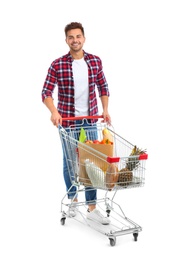 Photo of Young man with full shopping cart on white background