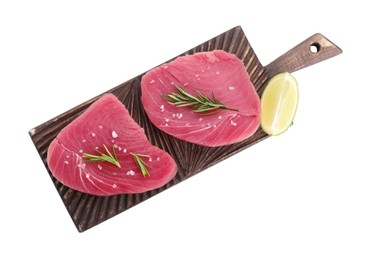 Photo of Raw tuna fillets with salt, rosemary and lime wedge on white background, top view