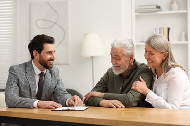 Notary consulting senior couple about Last Will and Testament in office