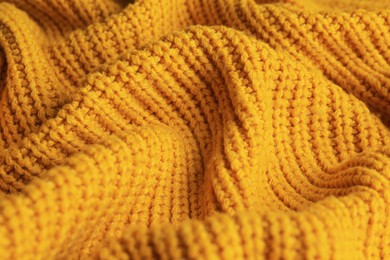 Photo of Beautiful orange knitted fabric as background, closeup