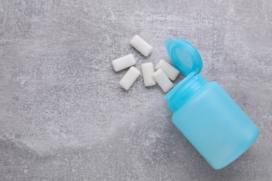 Jar with chewing gums on light grey table, flat lay. Space for text