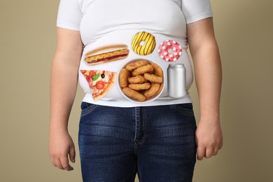 Overweight man in tight t-shirt with images of different unhealthy food on his belly against beige background, closeup