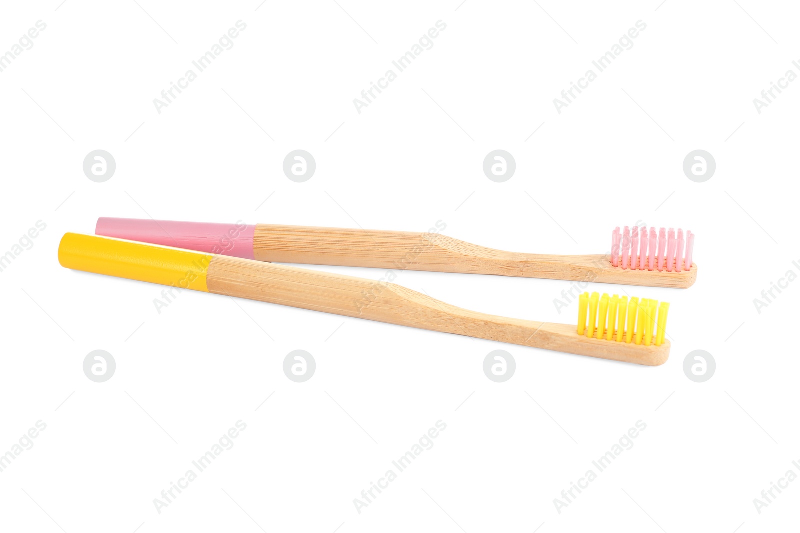 Photo of Natural bamboo toothbrushes with soft bristles isolated on white