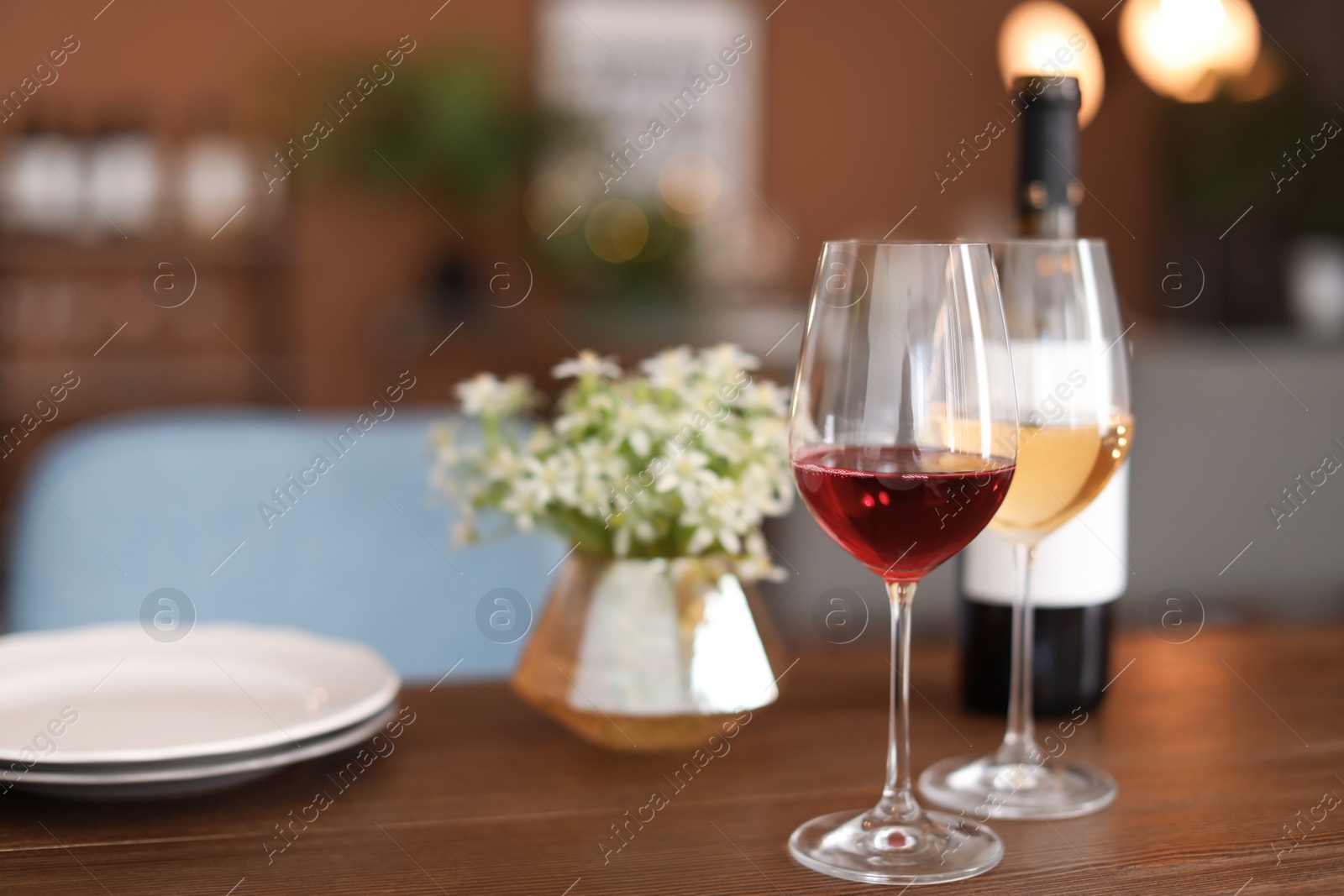 Photo of Glasses and bottle with tasty wine on table in restaurant