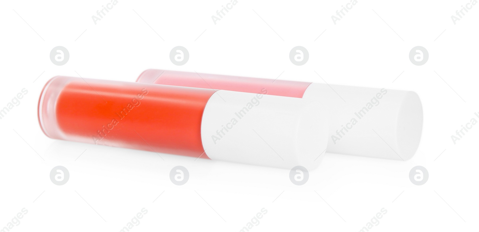 Photo of Two lip glosses isolated on white. Cosmetic products