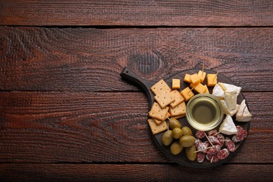 Photo of Toothpick appetizers. Pieces of sausage, cheese and honey on wooden table, top view with space for text